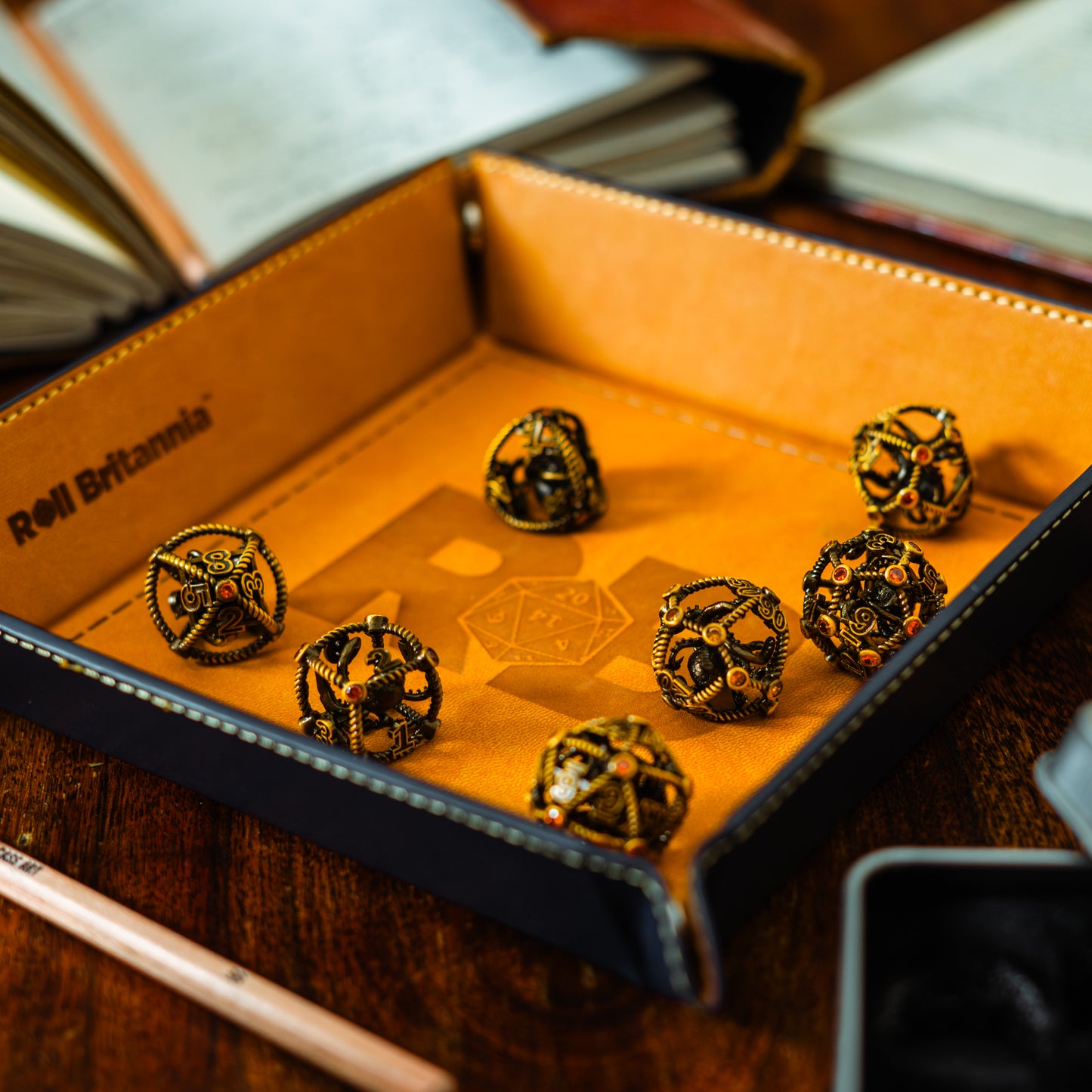 Roll Britannia Metal Dungeons and Dragons Dice Set with Nautical Kraken Aesthetic on leather branded dice tray