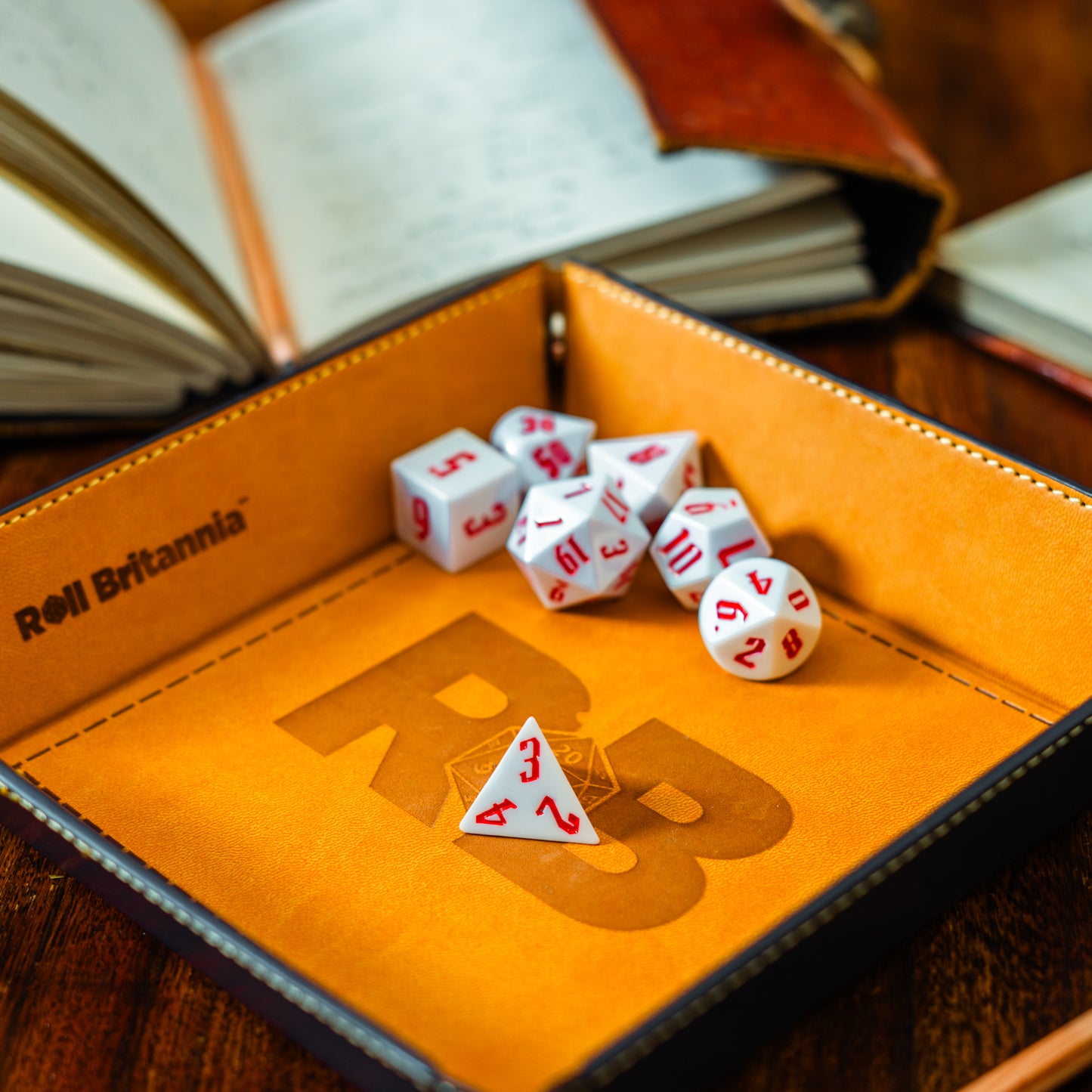 Roll Britannia Royal Guard Sharp Edged Electroplating Dungeons and Dragons Dice Set with Red and White Aesthetic on branded dice tray